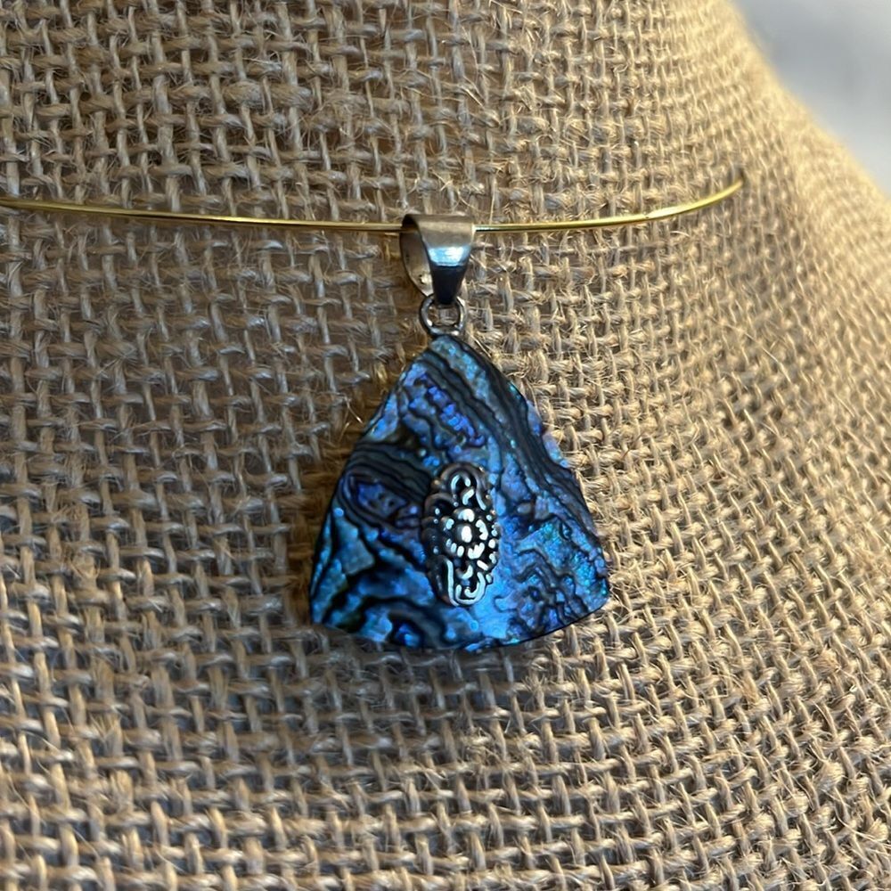 Triangle abalone shell pendant with sterling silver accents.